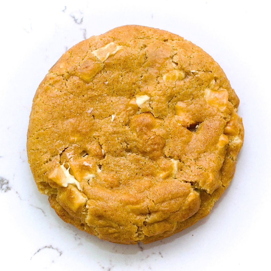 White Chocolate cookie with a golden surface and visible creamy chocolate pieces