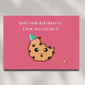 Pink birthday card with cartoon cookie and party hat, reads "Hope your Birthday is Crum-believeable"