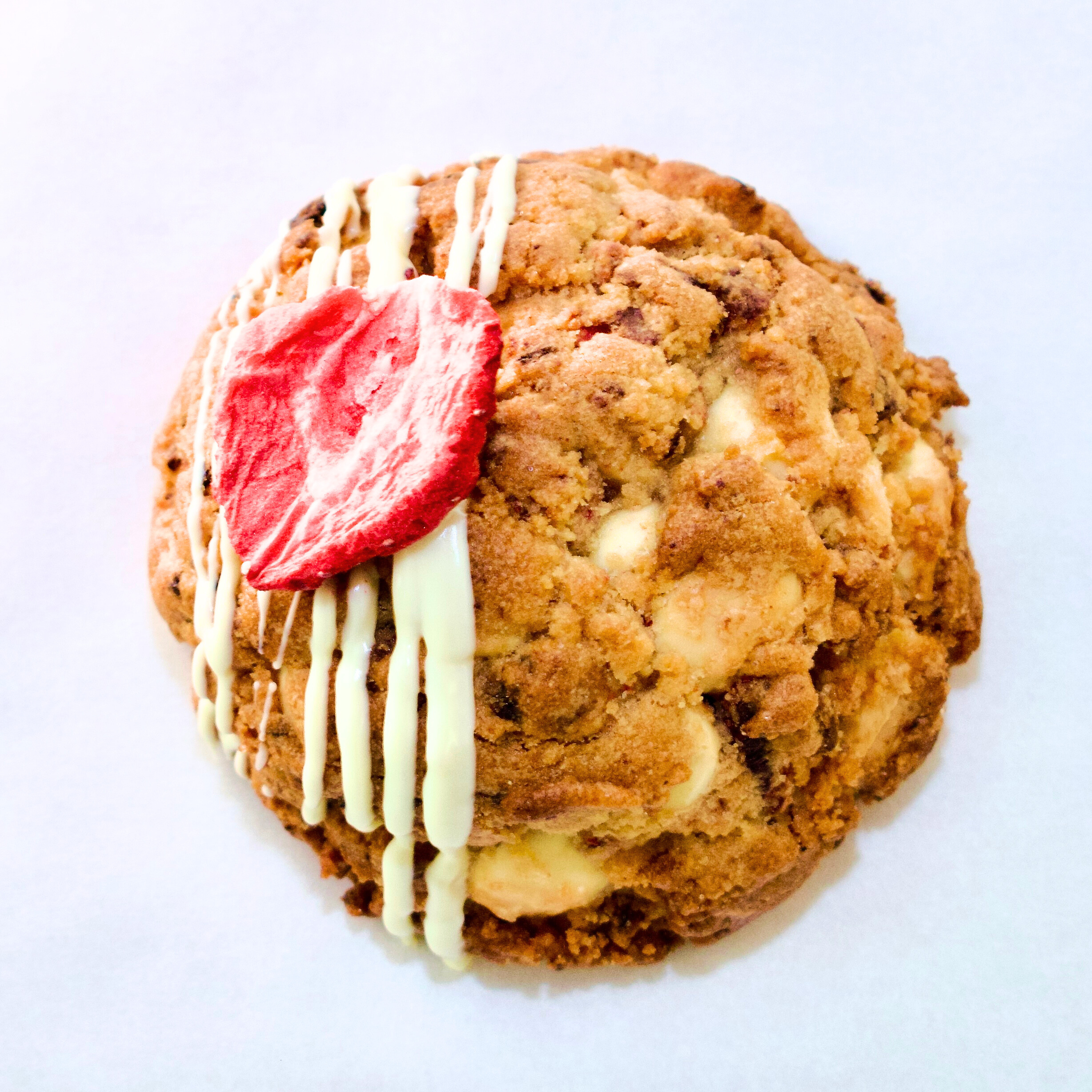 Strawberry and white chocolate New York-style cookie with visible chunks and soft centre