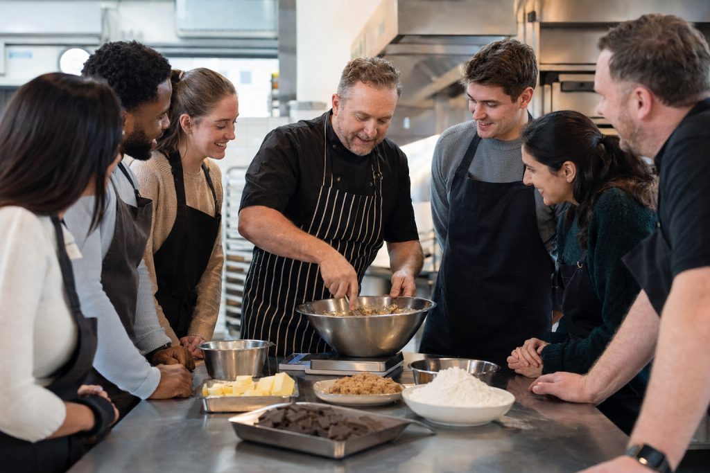 Professional baker demonstrating cookie dough during a corporate away day in London