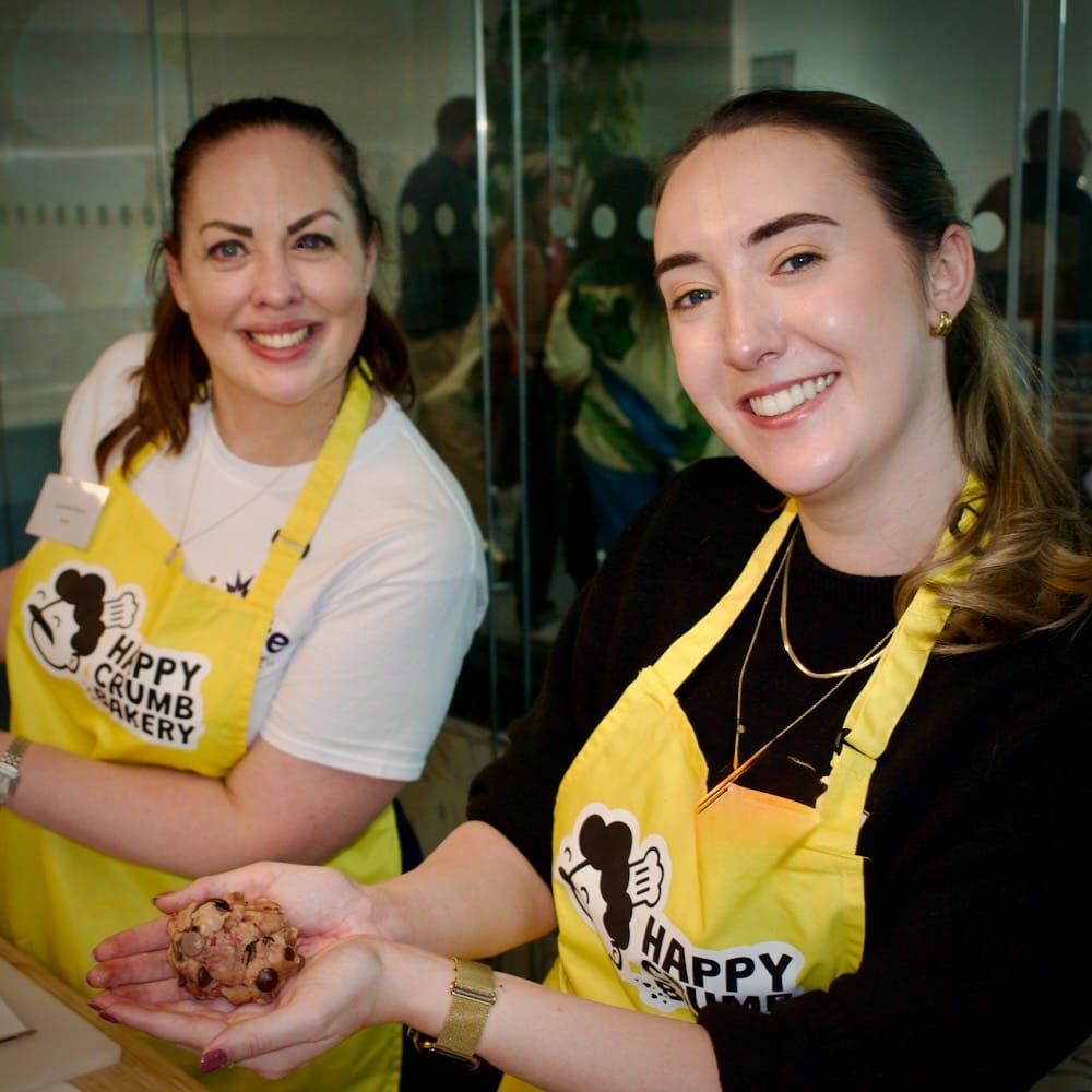 Participants enjoying small group team building activities in London at Happy Crumb Bakery's Cookie Lab.
